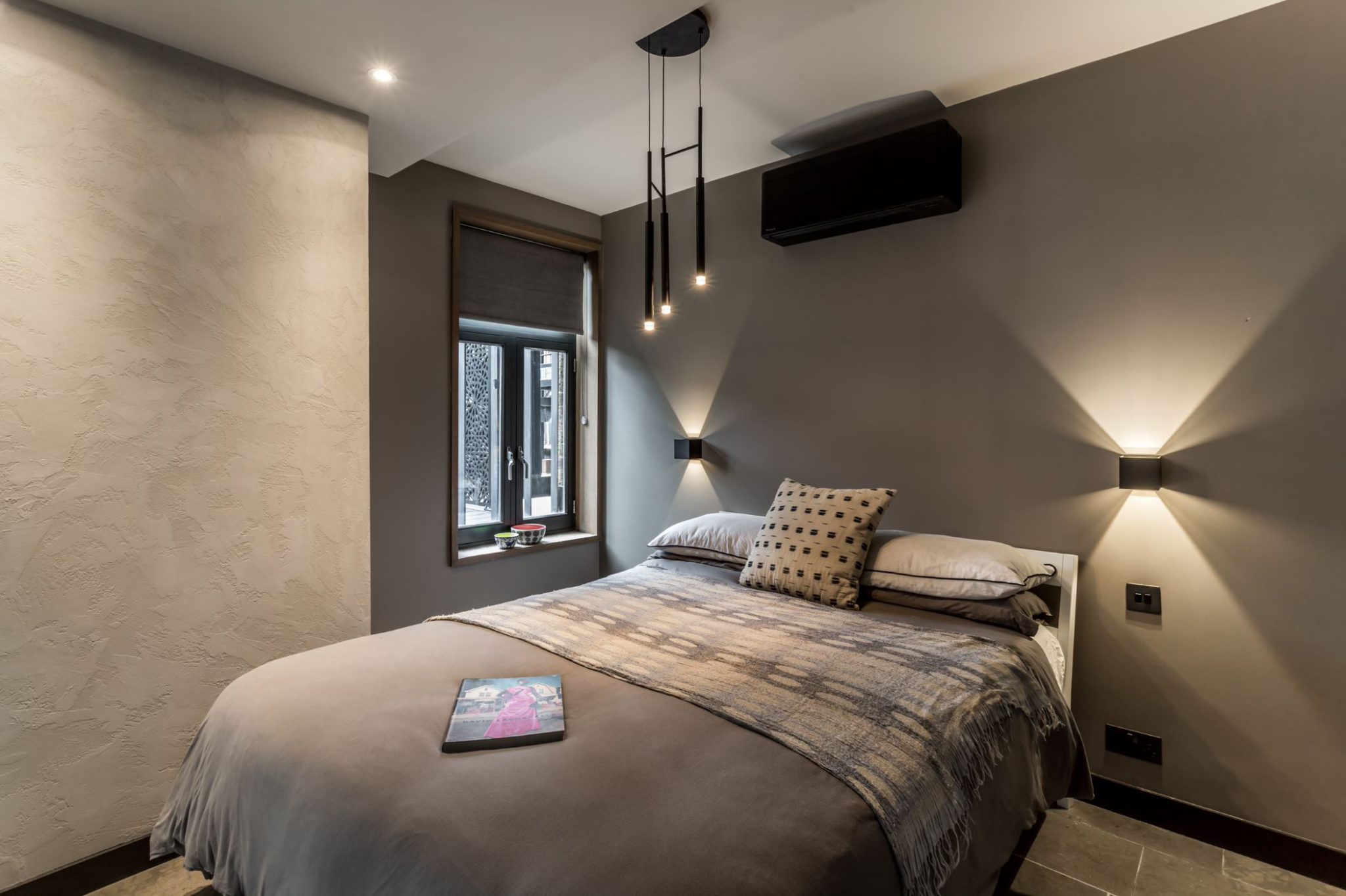 contemporary bedroom with statement lighting 