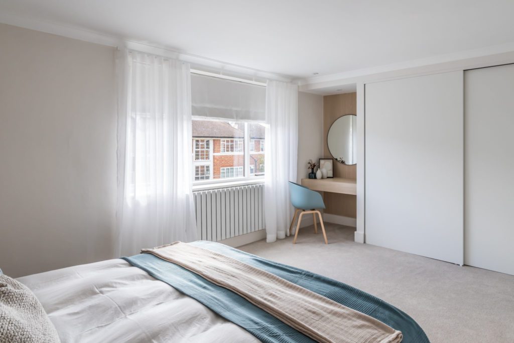 Built in dressing table and wardrobes in Scandi style bedroom 