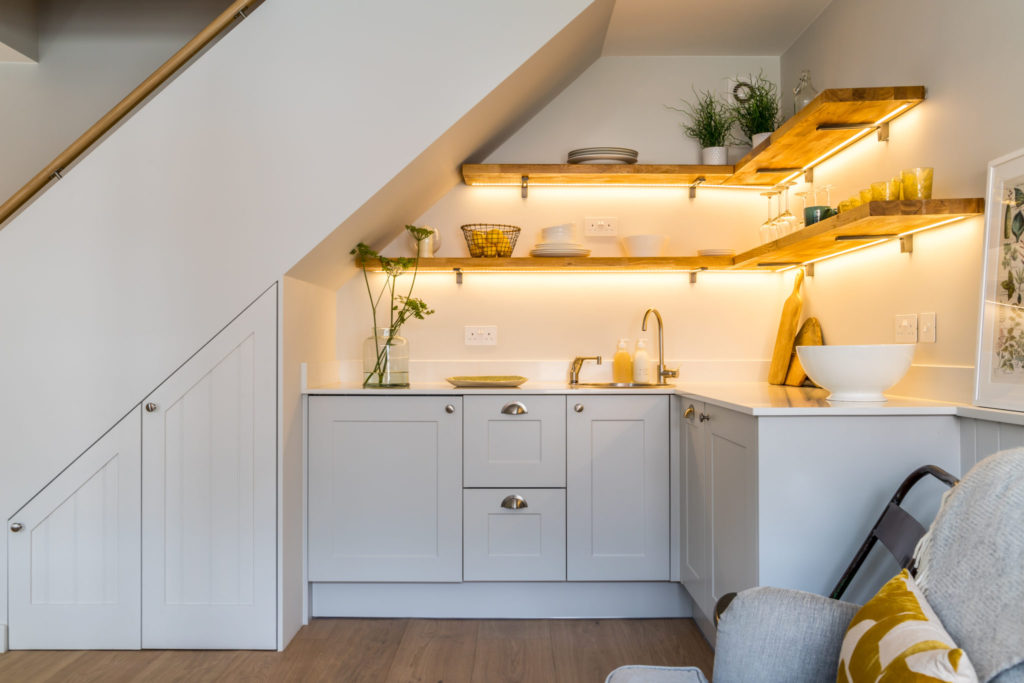 LED lit shelving in compact kitchen