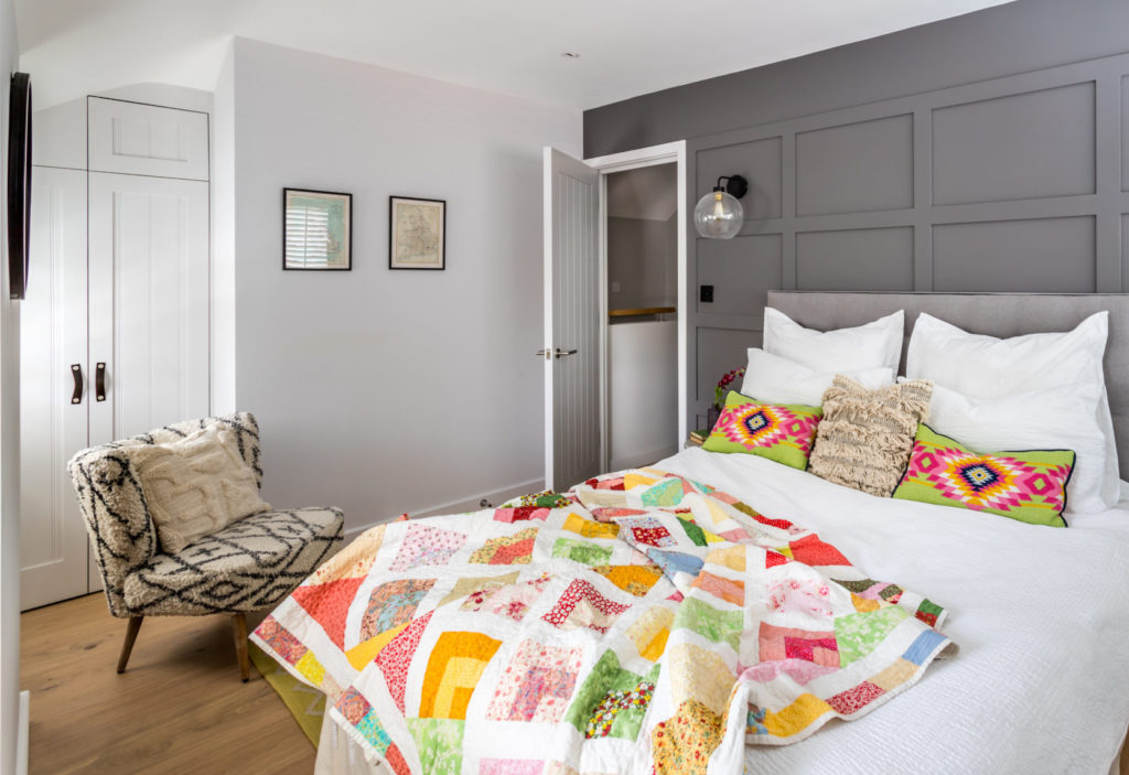 Beautiful patchwork quilt. Boutique hotel bedroom styling for this Surrey Studio design