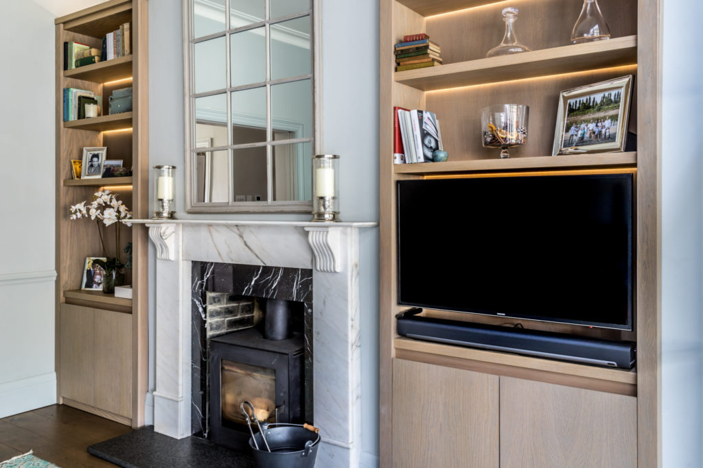 Surrey interior designer Amanda Delaney designed bespoke shelving with integrated TV