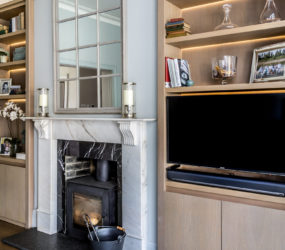 Surrey interior designer Amanda Delaney designed bespoke shelving with integrated TV