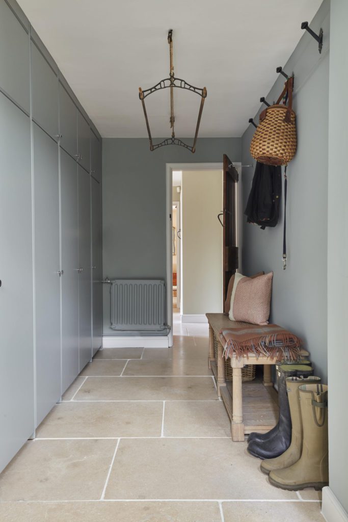 Country style boot room with porcelain floor tiles 